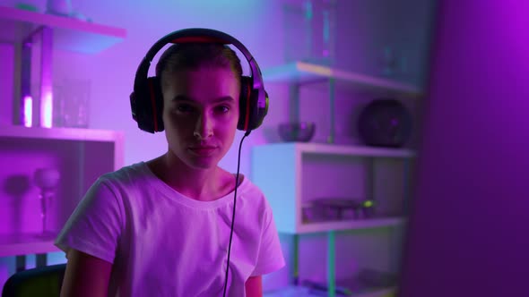 Closeup Beautiful Girl Gamer in Neon Lights at Home