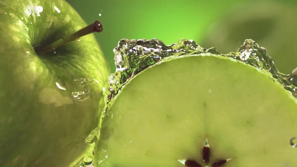 Slow Motion Shot of Green Apple Water Splashing Through Apple Slices