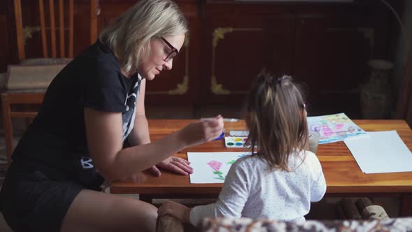 Child with Granny Drawing with Watercolor Paint at Home. Simple Living, Connection Concept