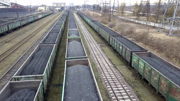 Long Row of Train Cargo Cars Loaded Full with Fossil Fuel Coal