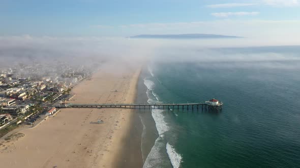 Manhattan Beach Pier On A Misty Day In California, United States - aerial pullback