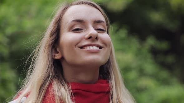 Portrait of Young Beautiful Woman Wearing Red Scarf Inhaling and Exhaling Fresh Air, Taking Deep