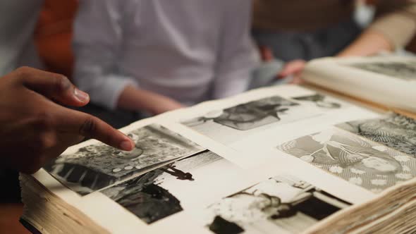 Black Man Points to Photo of Grandfather with Girl and Woman