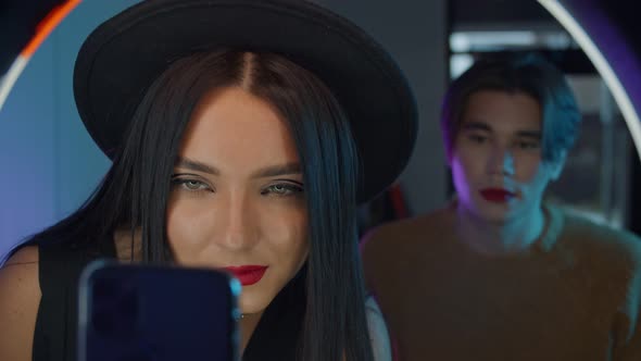 Makeup Studio - Young Handsome Man with Bold Red Lipstick and His Make Up Artist Standing in Front