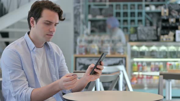 Young Man with Unsuccessful Online Payment on Smartphone