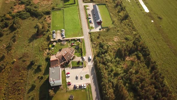 Caring down the provincial road among green trees. Aerial Shot 4K