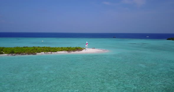 Beautiful flying clean view of a sunshine white sandy paradise beach and aqua turquoise water backgr