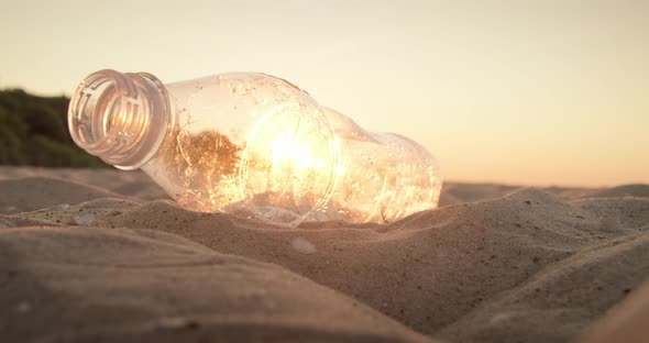 Cleaning Plastic From the Sandy Beach at Sunset