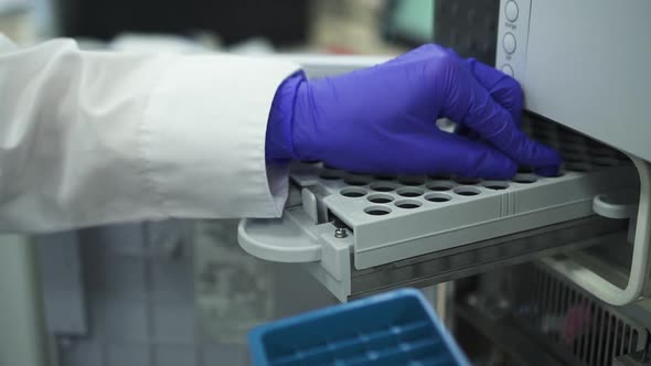 Closeup Doctor Scientist Inserting Bottles Dna Hiv Blood Test Tubes in Pcr Machine Spbd