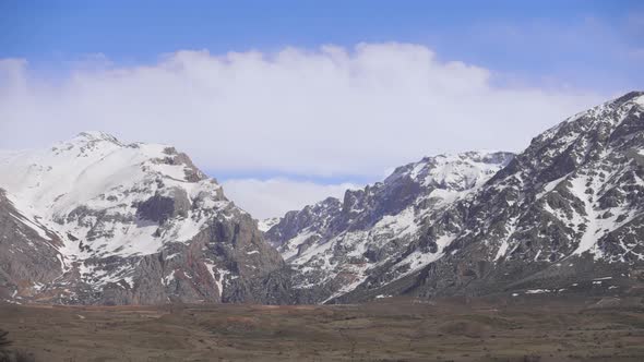 Time lapse of cloud shadows as low cloudse over mountainous terrain