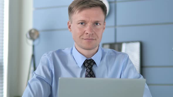 Smiling Businessman in Office