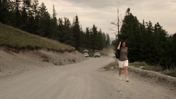 The girl is hitchhiking alone.