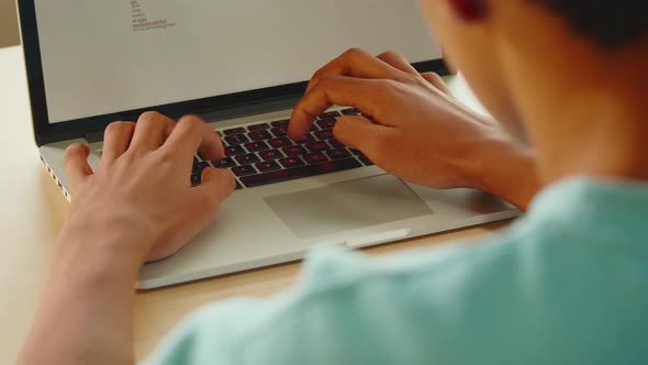 African American Man Typing on Laptop Keyboard Closeup