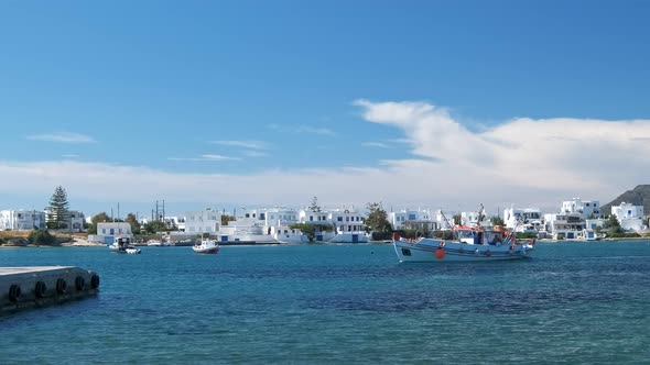 Fisherman Boat Arrive at Pier in Milos Island, Greece on Sunny Day