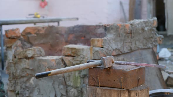 Young Blacksmith Works Metal. Craftsman, the Highlander on Private Smithy in the Village