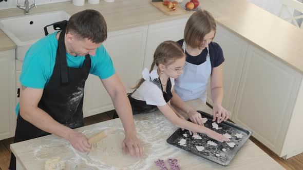 Father Mother and Daughter are Baking Together