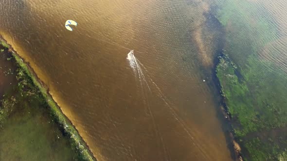 Aerial view of person kitesurfing on caiupe Lagoon in Brazil.