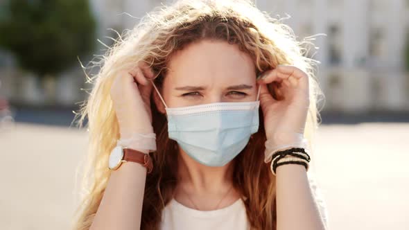 Happy Hispanic Girl Walking Outdoor While Taking Off Her Protective Face Mask and Looking at Camera