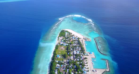 Wide angle aerial abstract shot of a white sand paradise beach and aqua blue ocean background in 4K