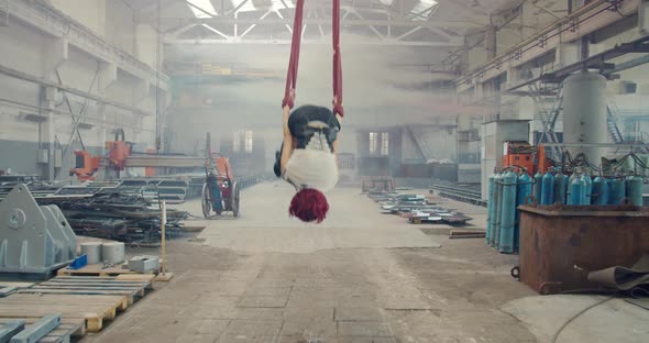 Redhead Woman Is Doing Aerial Gymnastics and Then Walks Off Gas Mask