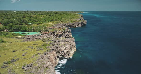 Cliff Ocean Coast with Green Plants Trees at Azure Limpid Lake