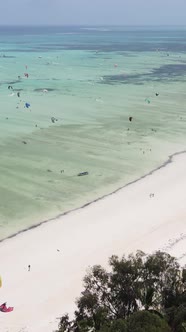 Vertical Video Kitesurfing Near the Shore of Zanzibar Tanzania