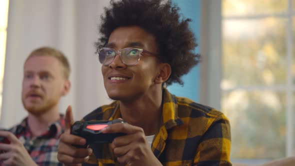 Joyful Young Multiethnic Men Playing Video Game Console.