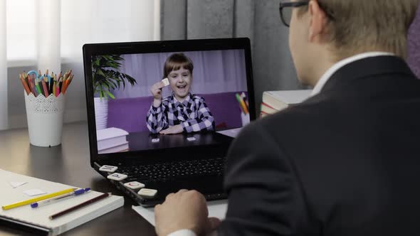 Man Teacher Makes Video Call on Laptop with Children Pupil. Distance Education