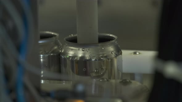 Close Up Shot Of Beer Can Being Filled On Microbrewery Canning Line