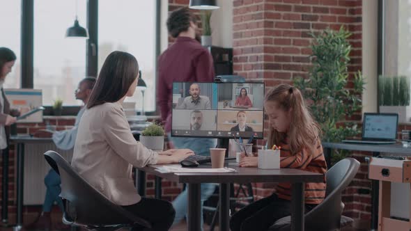 Single Mom with Child at Work Attending Video Call Meeting on Computer