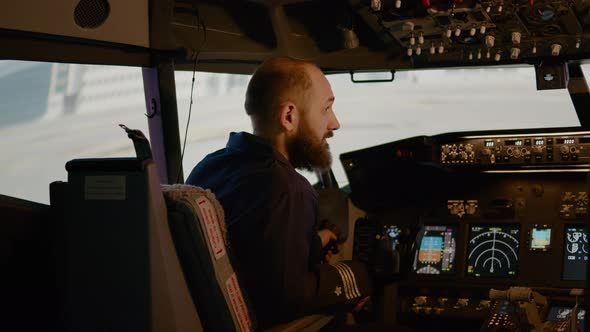 Portrait of Airplane Captain Preparing to Fly Aircraft in Cockpit