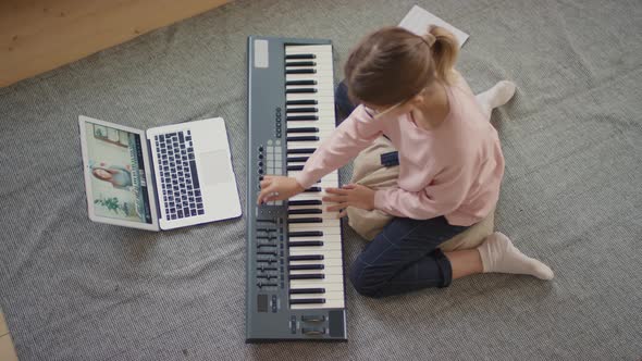Girl Playing Keyboard At Home