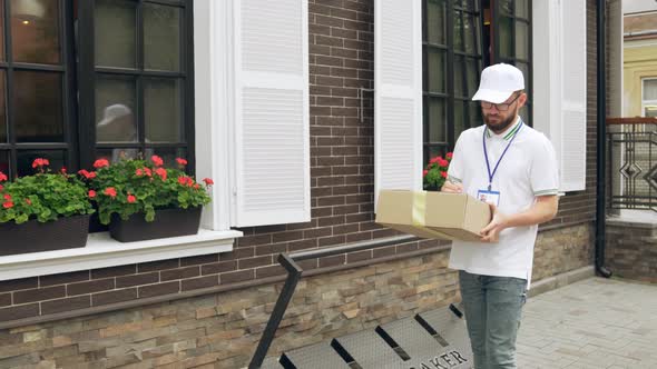 Male Courier with Name Tag Delivering Parcel.