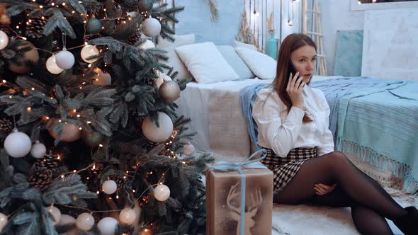 Woman Talking on the Phone Irritated By the Fact That She Spends Only the New Year