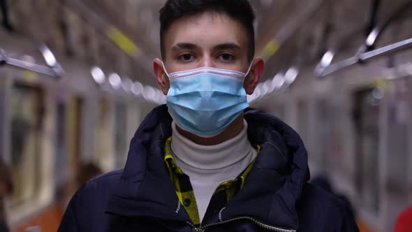 Teenage Boy Wearing Medical Face Mask in Metro Car