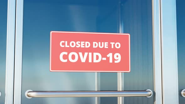 Closed due to COVID-19. Zooming in red close sign on the glass front door. 4K HD