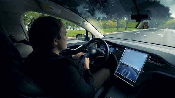 An Automatic Automobile Is Moving Along the Road with Its Driver Sitting Inside