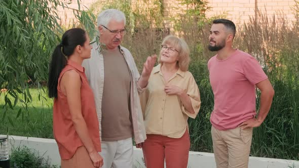 Multigenerational Couples Chatting Outdoors