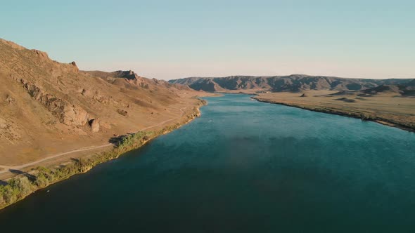 Drone Shot of River and Mountains at Sunset in Kazakhstan