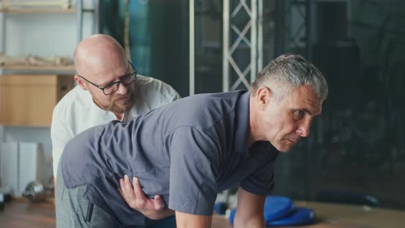 Physiotherapist Conducting a Rehabilitation SessionFor a Man with a Brain Stroke