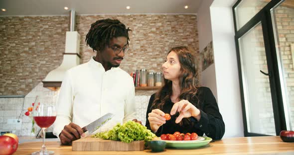 Young Couple Cut Vegetables Cook Together in Kitchen