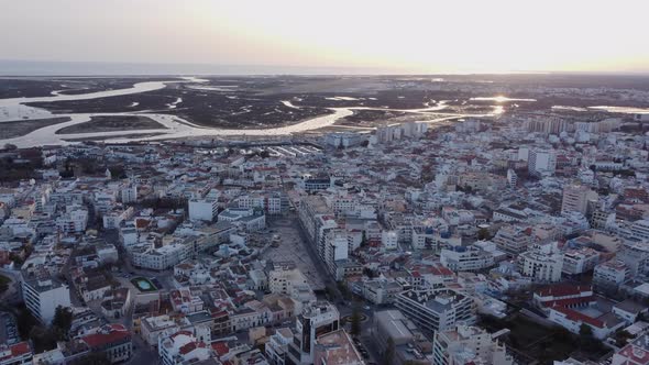 View of city of Faro at sunset, Portugal. Aerial orbit