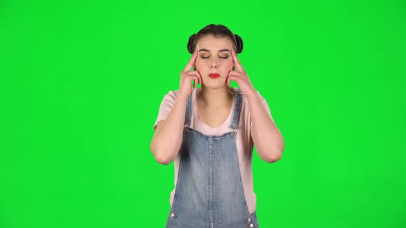 Woman Suffering From Headache From Fatigue on Green Screen at Studio