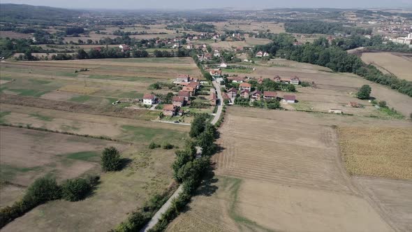 Aerial of a Village in the Balkans View of Houses and Farm Land