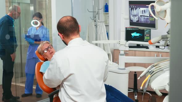 Doctor and Patient Talking About Denture Problems