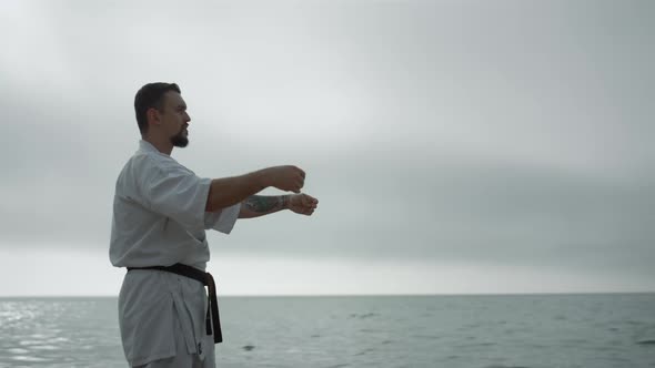 Bearded Sportsman Practicing Martial Arts Standing Beach