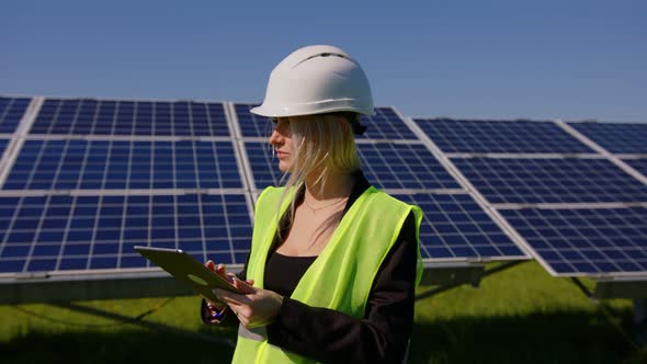 Female Ecological Engineer Uses Digital Tablet and Collects Efficient Information About Solar Panels