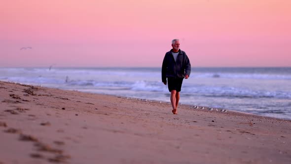 Senior Man Exercising At The  Beach