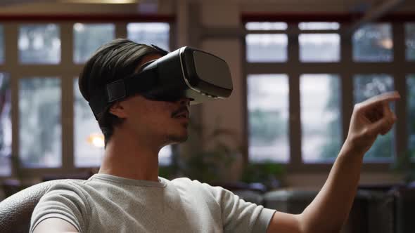 Mixed race man using virtual reality headset