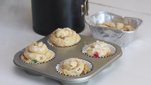 A Woman Prepares A Cruffin With Raisins And Candied Fruits.